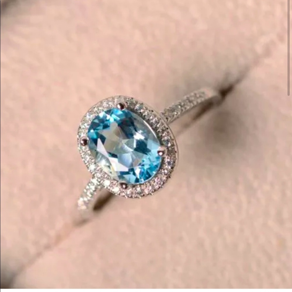 SILVER BLUE AND WHITE TOPAZ OVAL SHAPED HALO RING